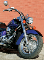 Wire spoked wheels and subdued two-tone paint provoke second glances. Wire spoked wheels and subdued two-tone paint provoke second glances.